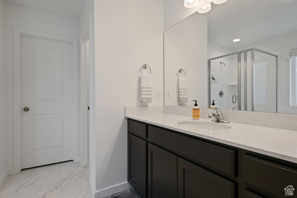 Full bathroom with a shower stall, baseboards, vanity, marble finish flooring, and recessed lighting
