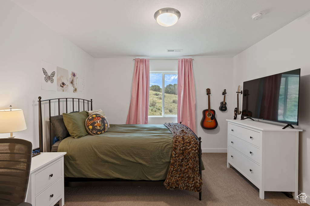Bedroom featuring carpet flooring and baseboards