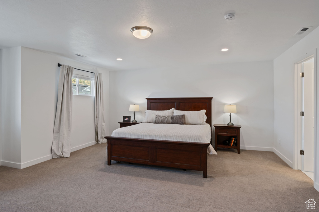 Bedroom with light carpet, baseboards, and recessed lighting
