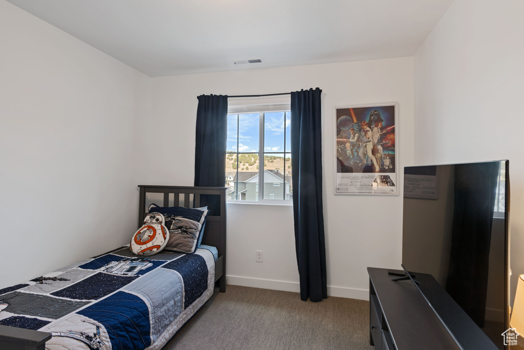 Carpeted bedroom with baseboards