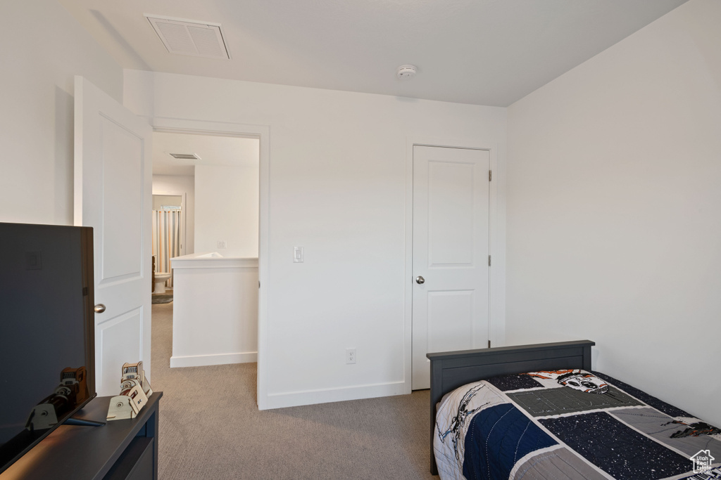 Carpeted bedroom with baseboards