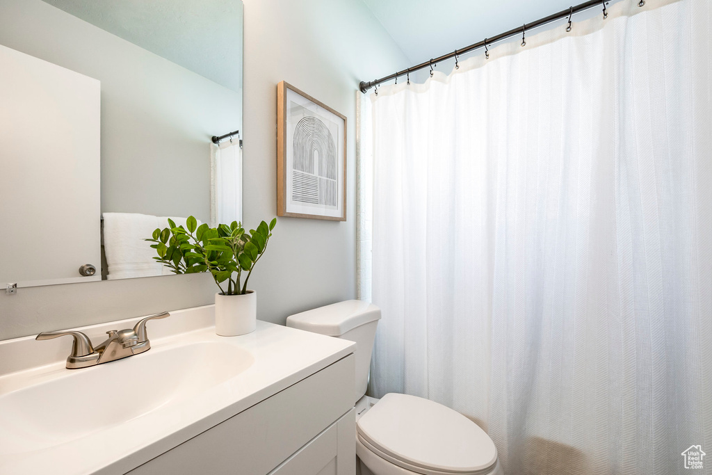 Full bathroom featuring toilet and vanity