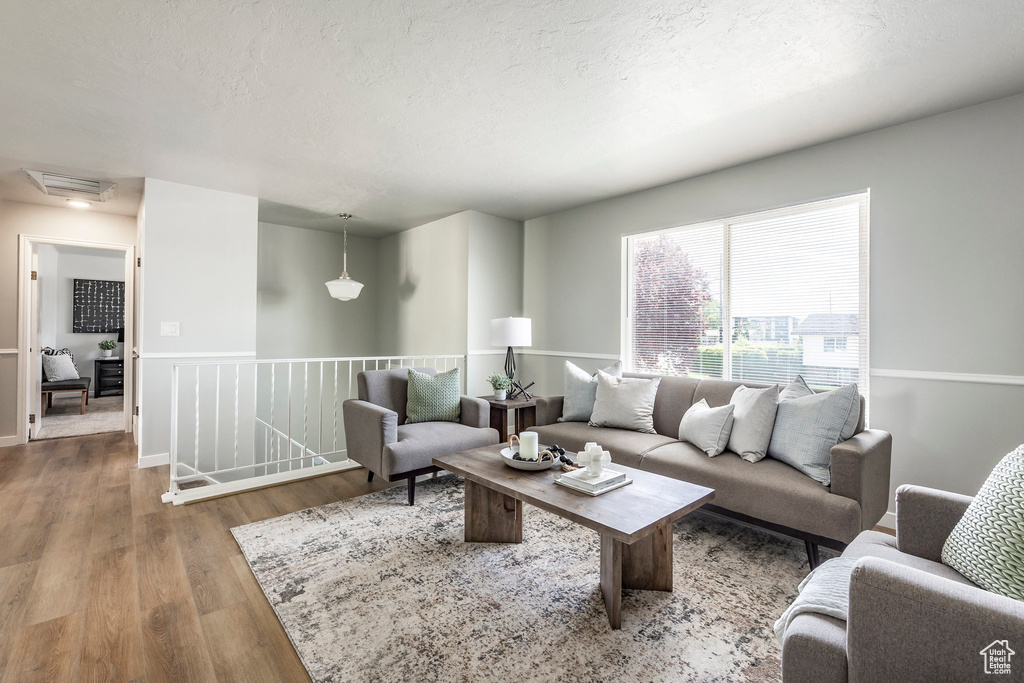 Living area featuring wood finished floors and a textured ceiling