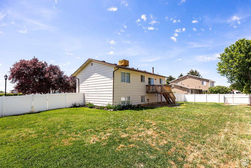 Rear view of property with stairs and a deck