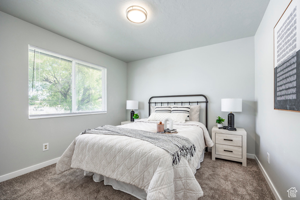 Carpeted bedroom featuring baseboards