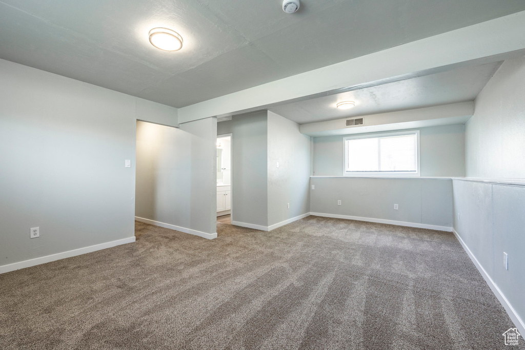 Unfurnished bedroom featuring carpet and baseboards