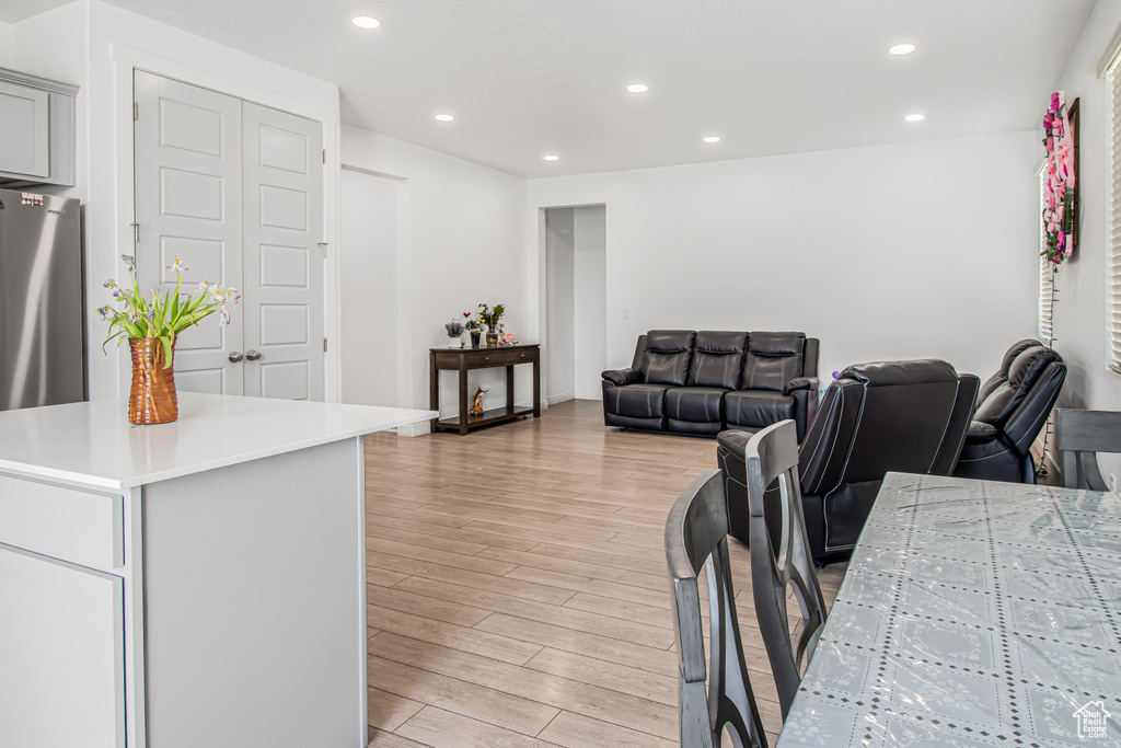 Living room with light wood-style floors and recessed lighting