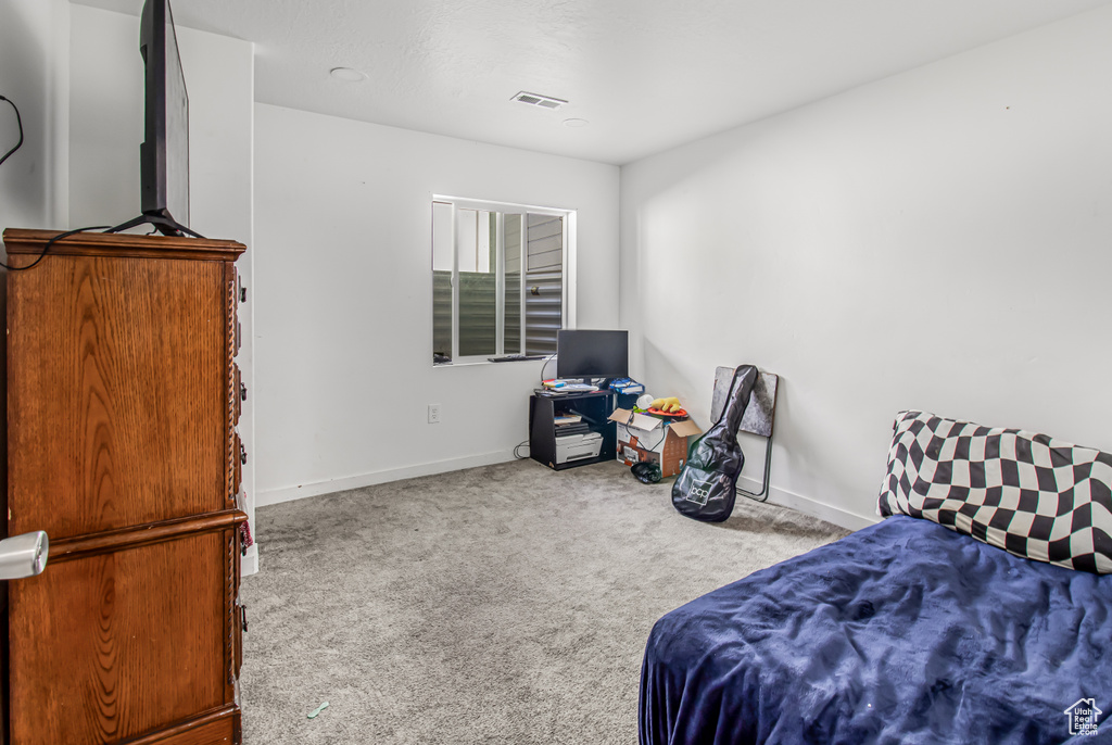 Carpeted bedroom with baseboards