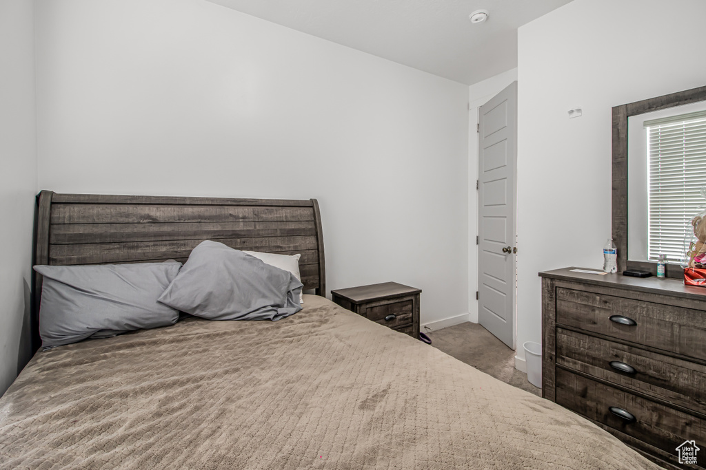 Bedroom with carpet floors and baseboards