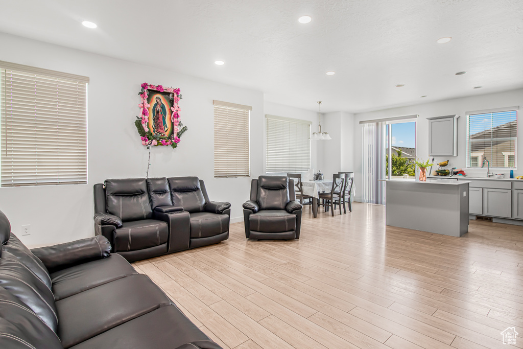 Living area featuring light wood finished floors and recessed lighting