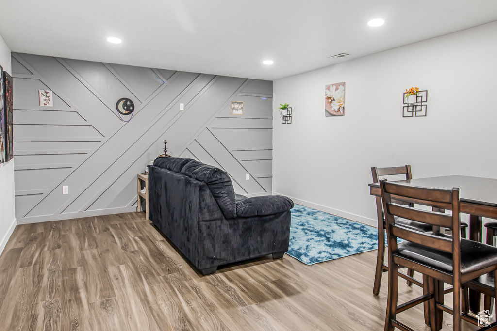 Living room with baseboards, wood finished floors, and recessed lighting
