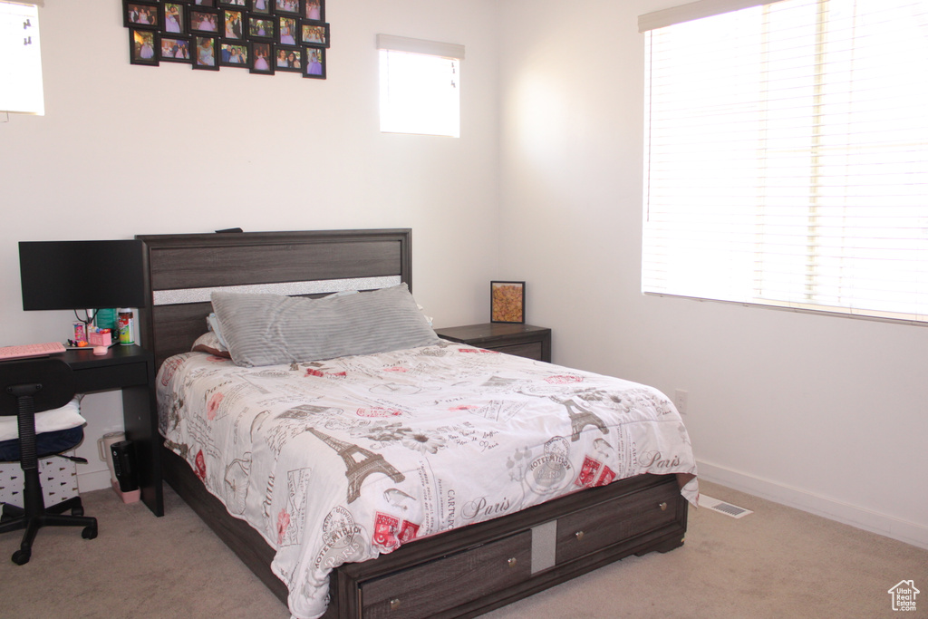 Carpeted bedroom featuring baseboards