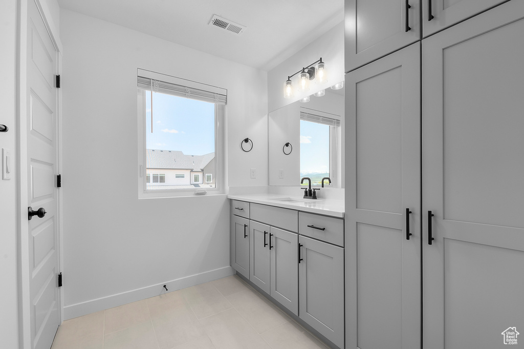 Bathroom featuring baseboards and vanity