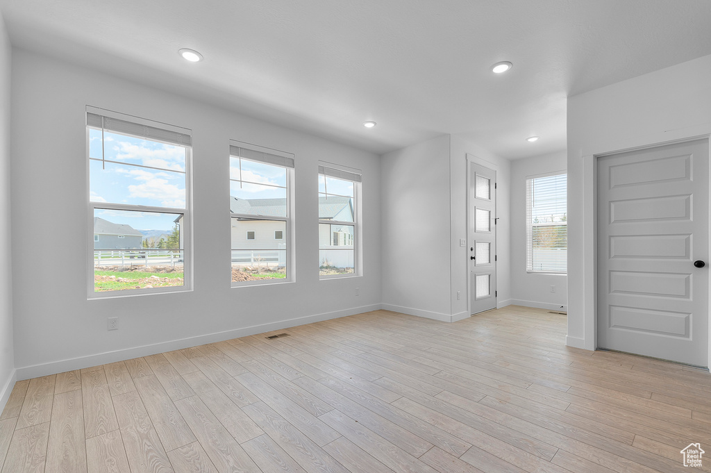 Foyer entrance featuring baseboards, light wood-style flooring, and recessed lighting