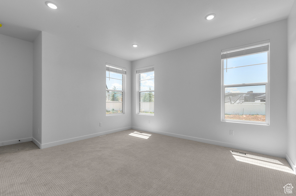 Spare room with carpet floors, recessed lighting, and baseboards