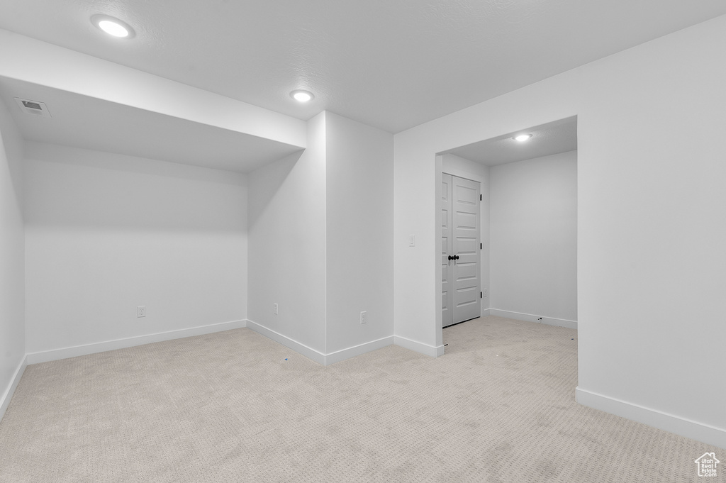 Below grade area with baseboards, carpet, and recessed lighting