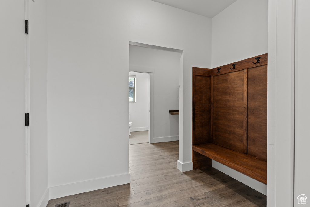 Mudroom with wood finished floors and baseboards