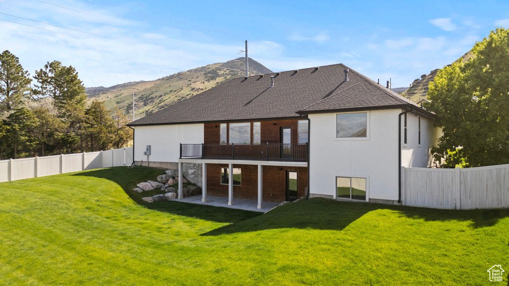 Back of house featuring a patio area and a mountain view