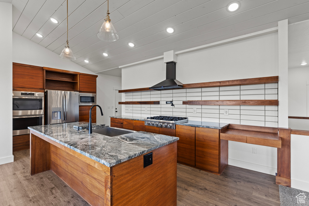 Kitchen featuring open shelves, appliances with stainless steel finishes, a sink, brown cabinets, and recessed lighting
