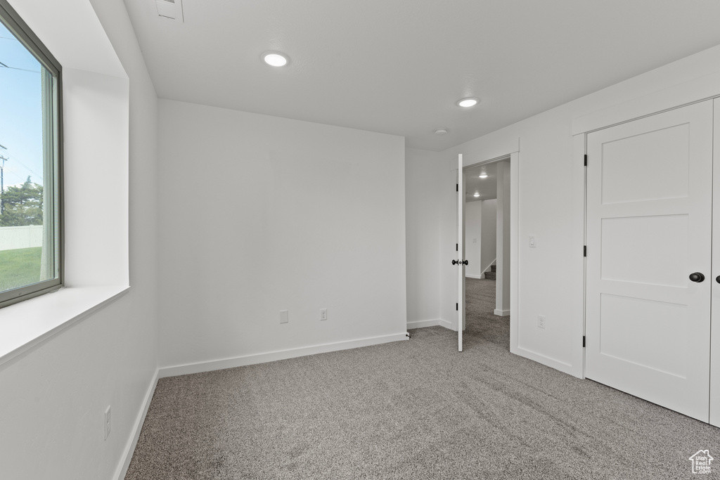 Unfurnished bedroom with carpet flooring, recessed lighting, and baseboards