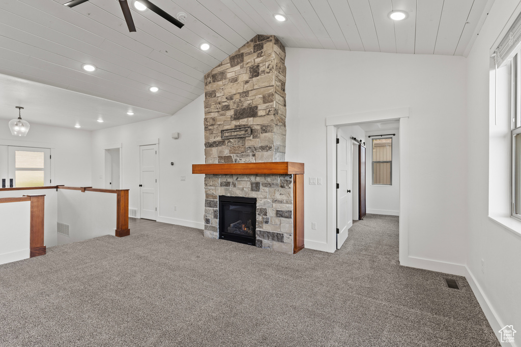 Unfurnished living room with carpet, recessed lighting, a fireplace, baseboards, and ceiling fan