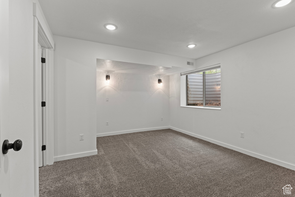 Carpeted spare room featuring recessed lighting and baseboards