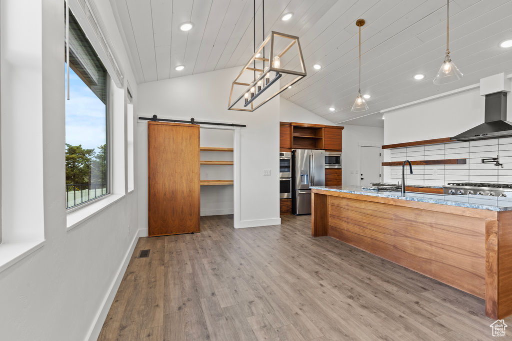 Kitchen featuring open shelves, appliances with stainless steel finishes, baseboards, recessed lighting, and a barn door