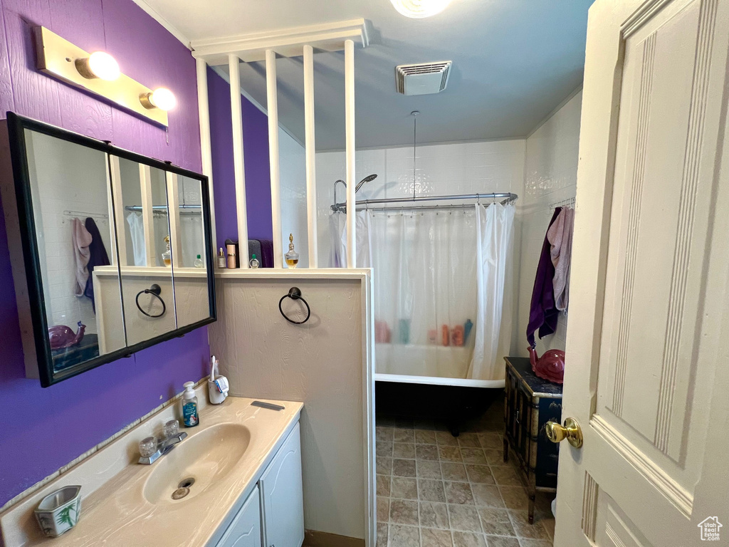 Bathroom featuring shower / tub combo with curtain and vanity