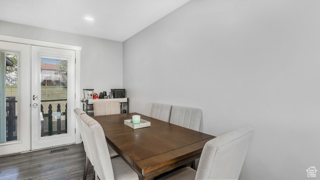 Dining room with wood finished floors and recessed lighting
