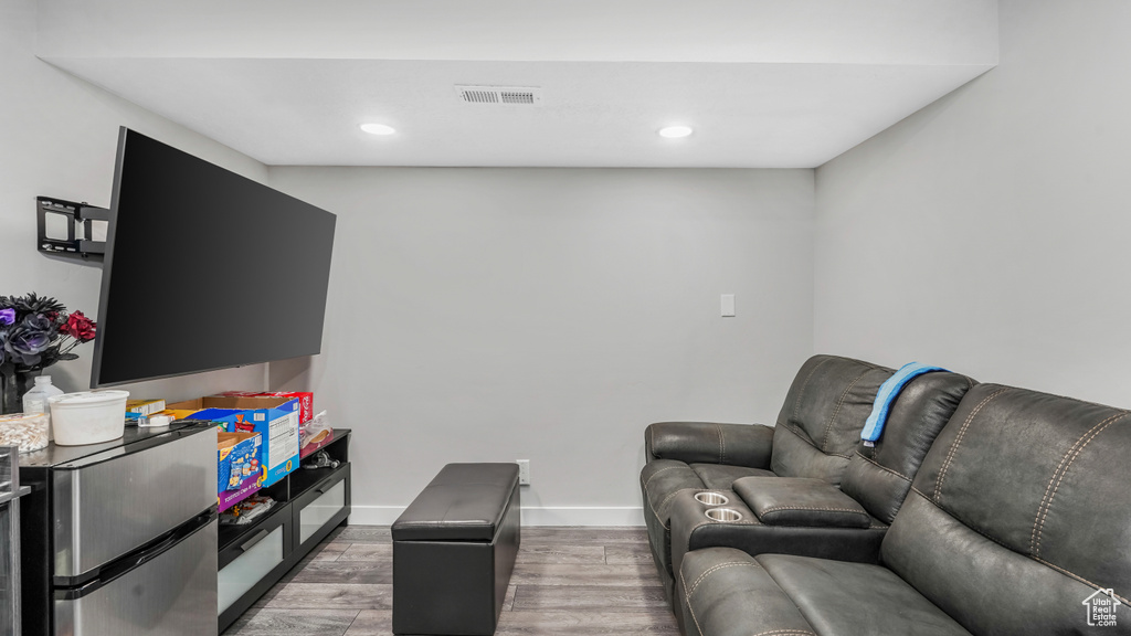 Living area featuring light wood finished floors, recessed lighting, and baseboards