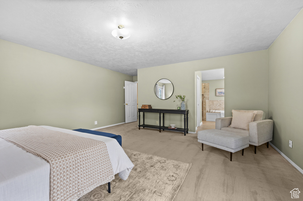 Bedroom featuring light carpet and baseboards