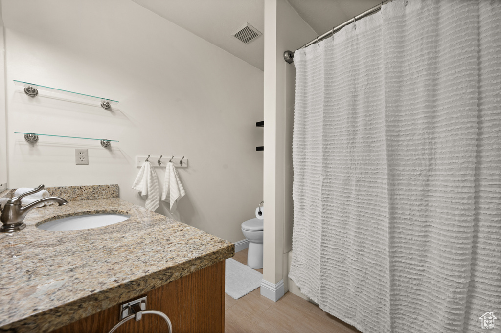 Full bath featuring toilet and vanity
