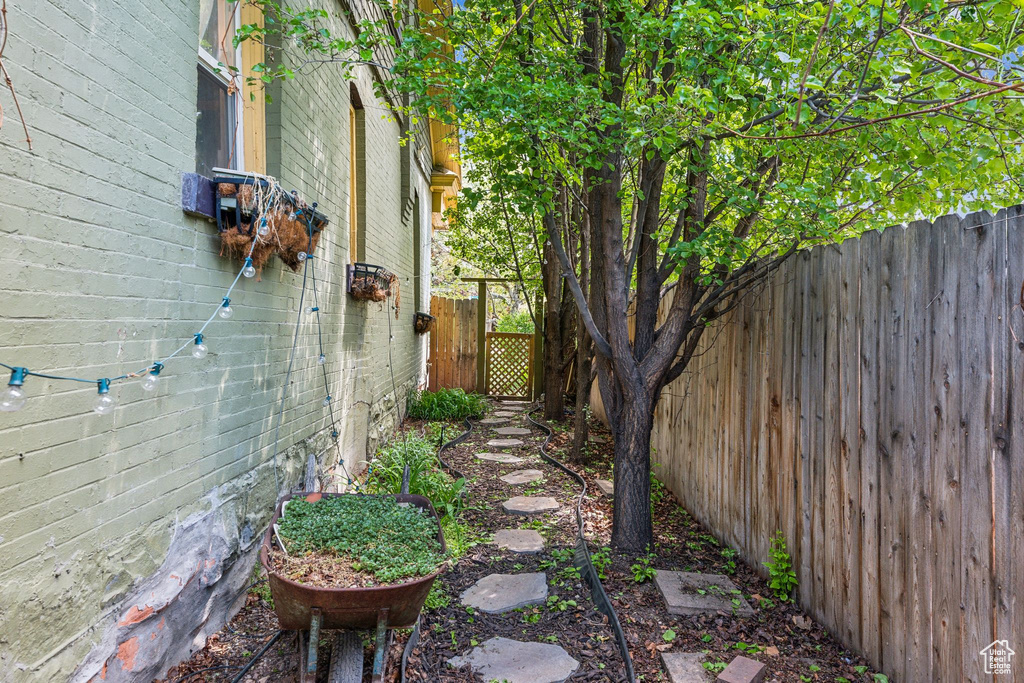 View of property exterior with fence and a gate