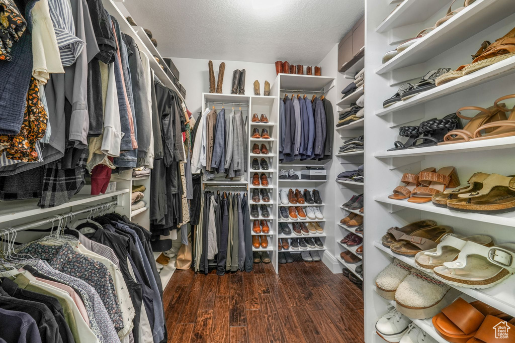 Walk in closet with wood finished floors