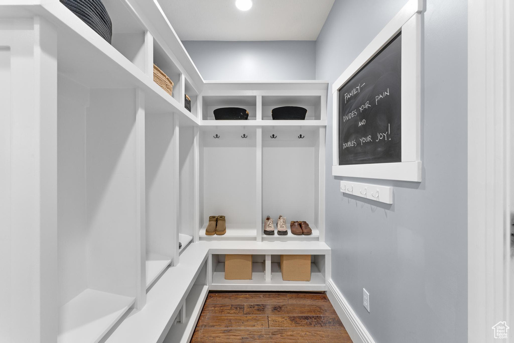Mudroom with dark wood finished floors and baseboards