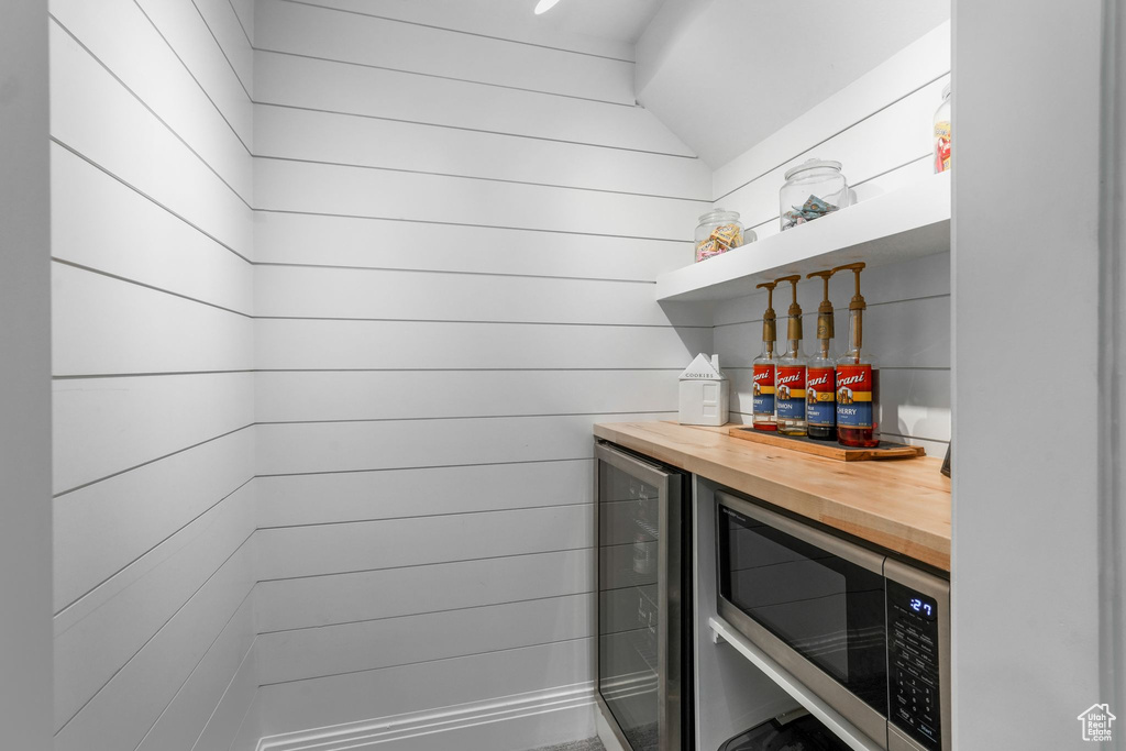 Indoor dry bar with wine cooler and stainless steel microwave