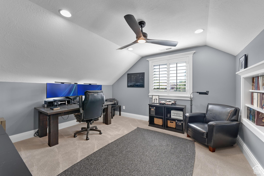Office featuring vaulted ceiling, a ceiling fan, carpet, a textured ceiling, and baseboards