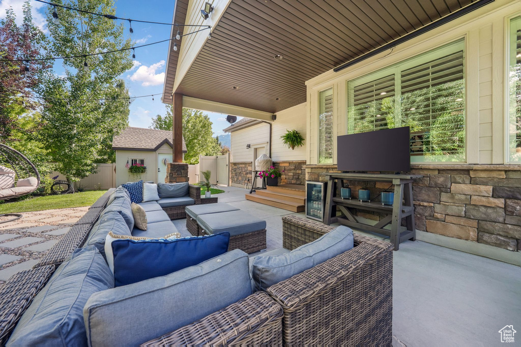 View of patio with an outdoor hangout area and an outbuilding