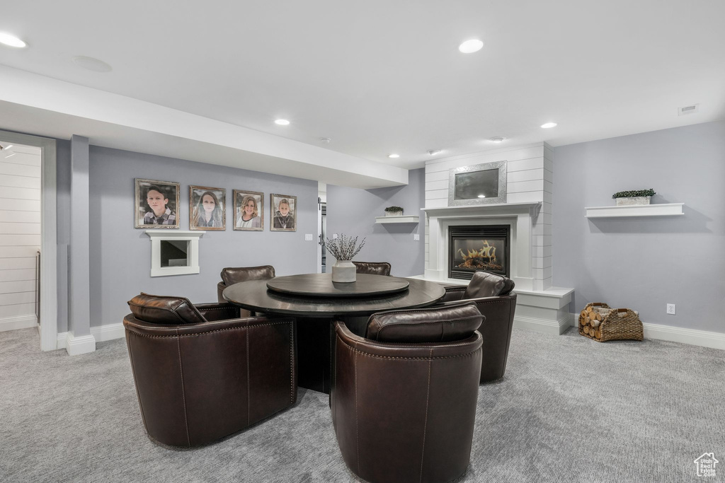 Living area featuring carpet, a fireplace, and recessed lighting