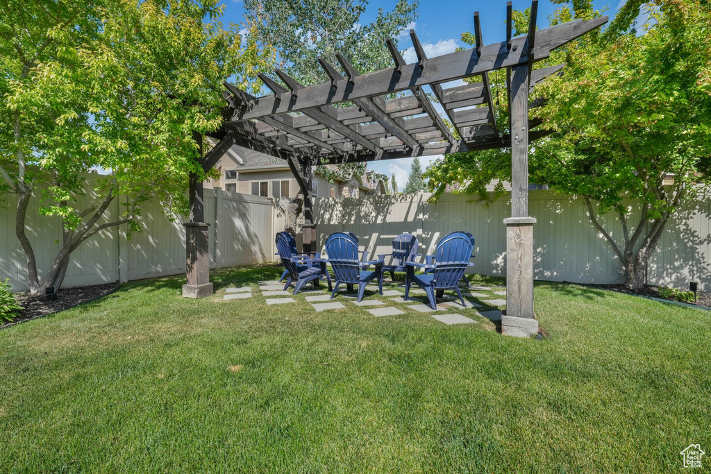 Fenced backyard with a pergola