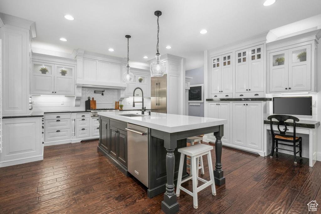 Kitchen featuring dishwasher, white cabinetry, decorative backsplash, dark wood finished floors, and recessed lighting