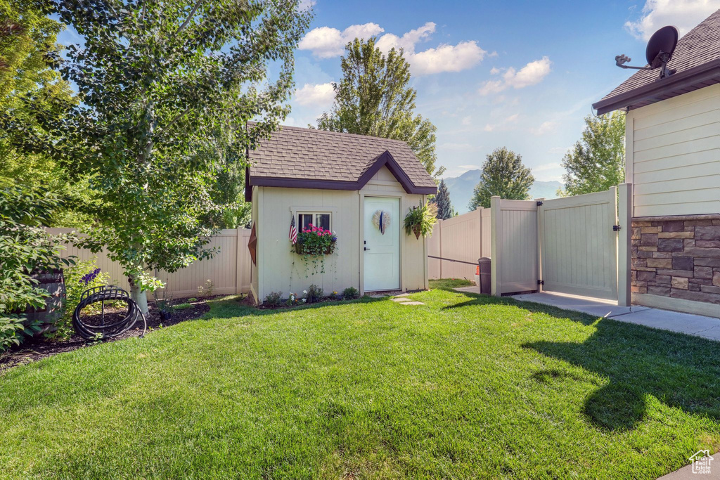 Fenced backyard with a shed and a gate