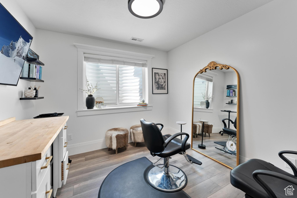 Living area with light wood-style flooring and baseboards