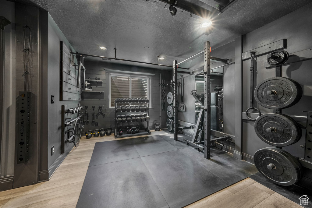 Workout room featuring wood finished floors and a textured ceiling