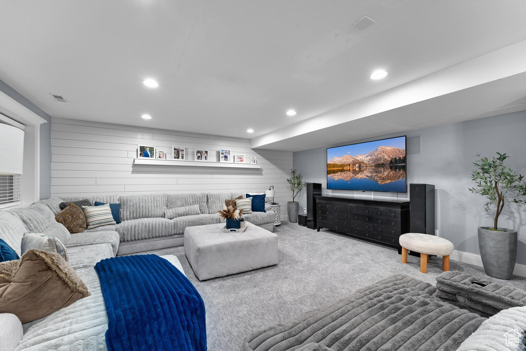 Carpeted living room with recessed lighting and baseboards