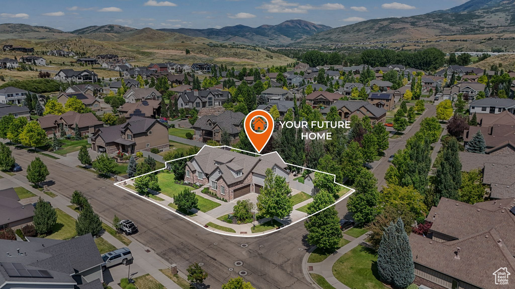 Aerial perspective of suburban area with property boundaries highlighted and mountains