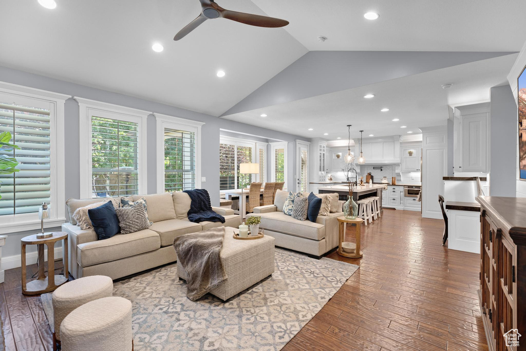 Living area featuring ceiling fan, vaulted ceiling, dark wood finished floors, and recessed lighting