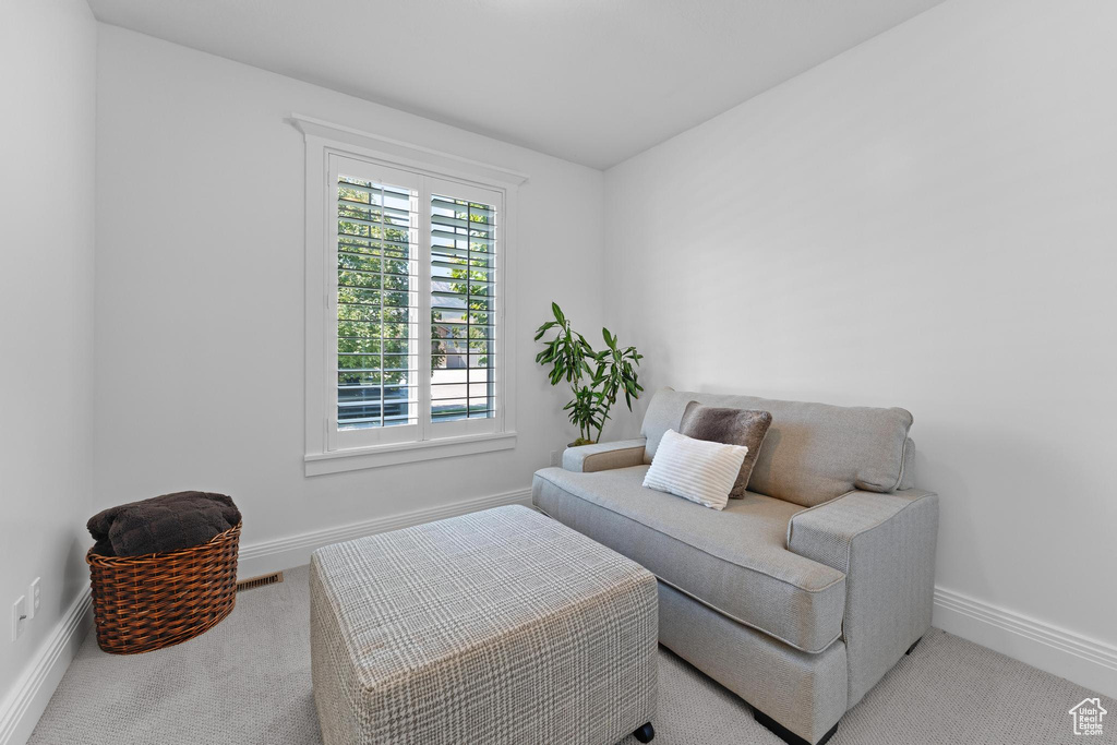 Sitting room with carpet and baseboards