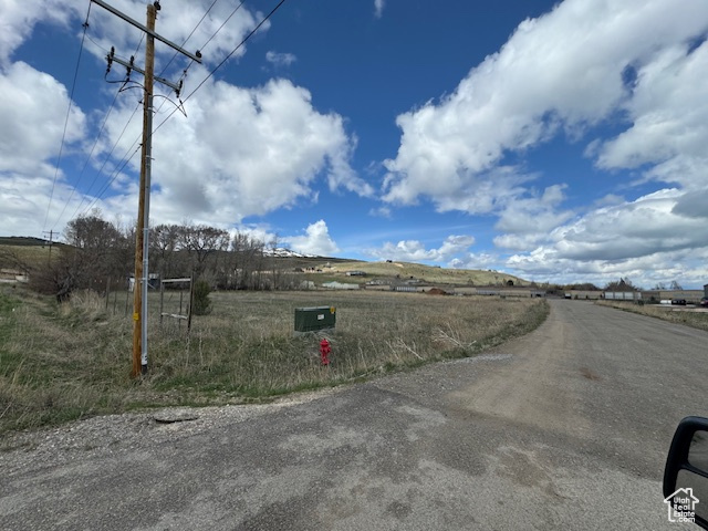 View of asphalt road featuring a rural view