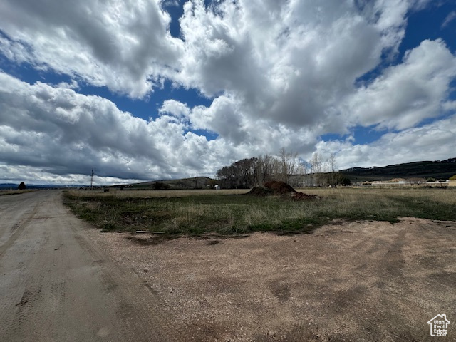 View of dirt / gravel road featuring a view of countryside